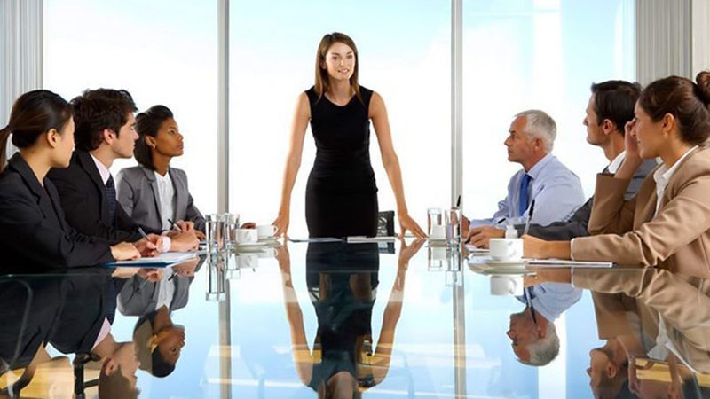 Group Of Business People Having Board Meeting Around Glass Table